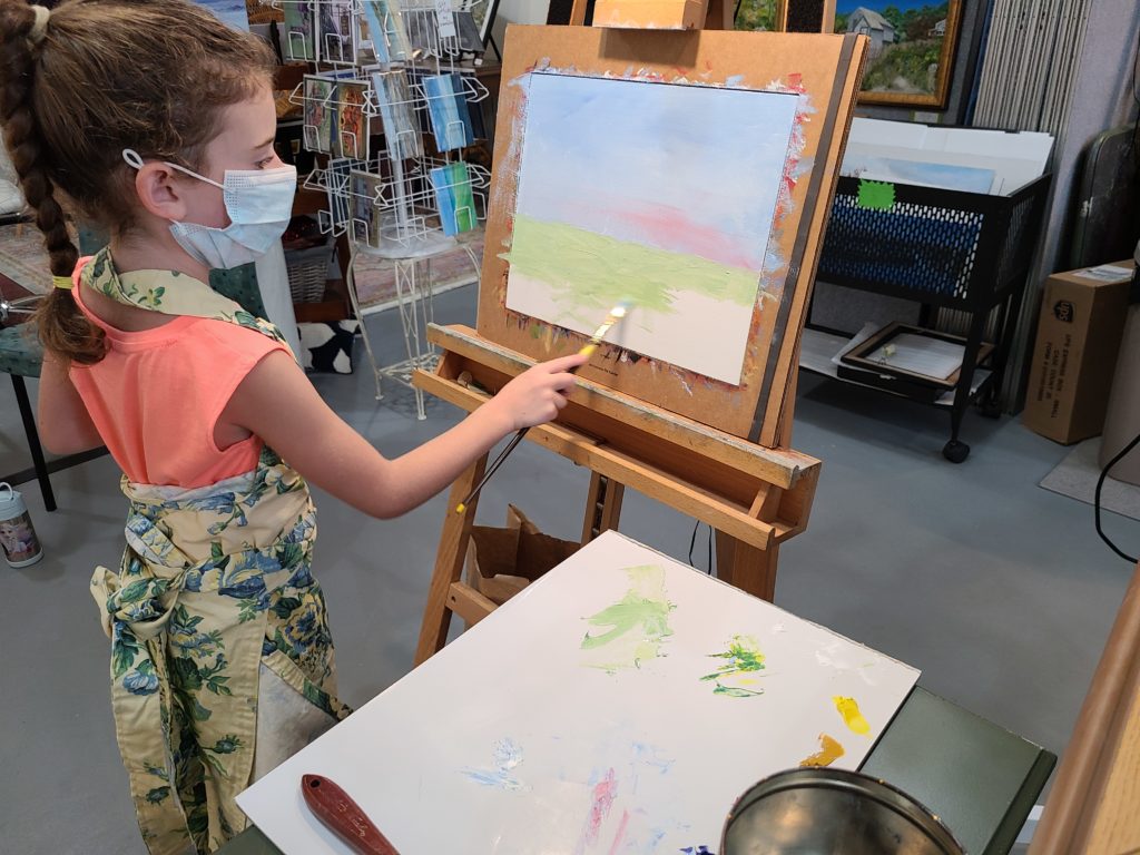 Ava demonstrates oil painting